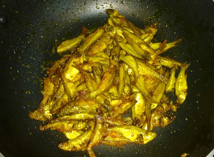 Just rub it with turmeric powder and salt, keep it for 10 minutes then fry it in smoky heated mustard oil; this is how to make morola mach bhaja/mola fish fry.